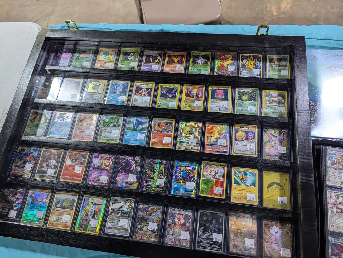 A display case full of Pokémon cards on their table
