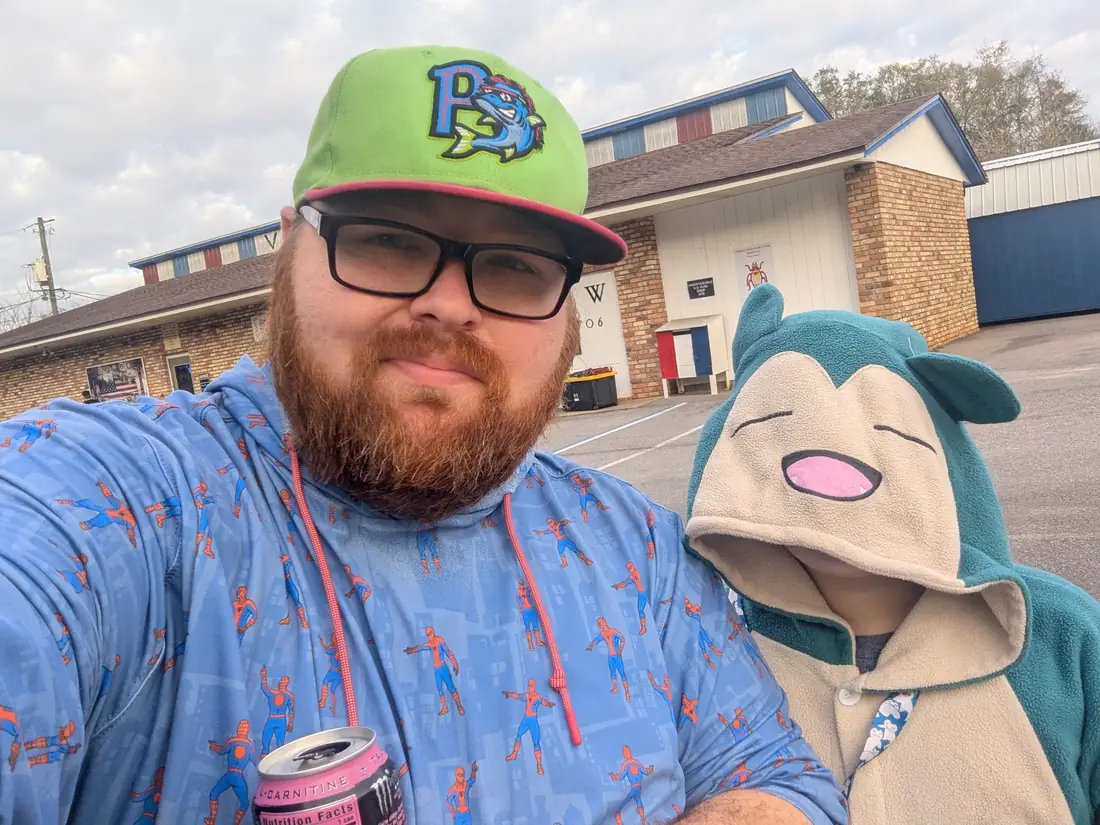 Mike taking a selfie with Mr. Lax in a Snorlax hoodie